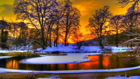 Winter Sunset Over a Snowy River Landscape wallpaper