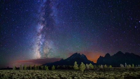 Majestic Milky Way Over Serene Mountains wallpaper