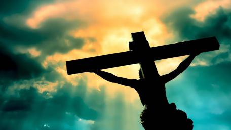 Silhouette of Faith Against a Dramatic Sky wallpaper
