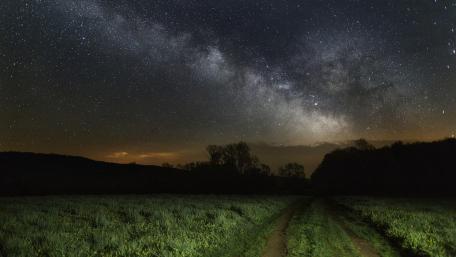 Milky Way over the dirt road wallpaper