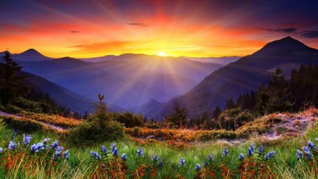 Breathtaking Highland Sunset Over Mountains and Meadows wallpaper
