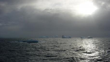Mystical Icebergs Beneath a Cloudy Sky wallpaper