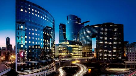Urban Nightscape of Modern Skyscrapers with Glowing Lights wallpaper