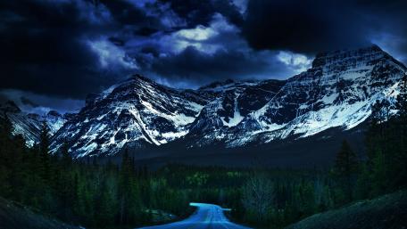 Majestic Mountain Wilderness Under Clouds wallpaper