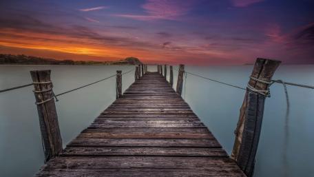 Serene Sunset Over Tranquil Pier Waterway wallpaper