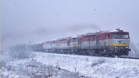 Winter Train Journey through Snowy Tracks wallpaper