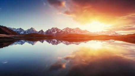 Serene Mountain Sunset Over Tranquil Lake Water wallpaper