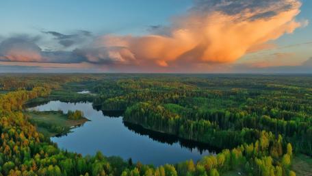 Serene Wilderness Under Colorful Clouds wallpaper