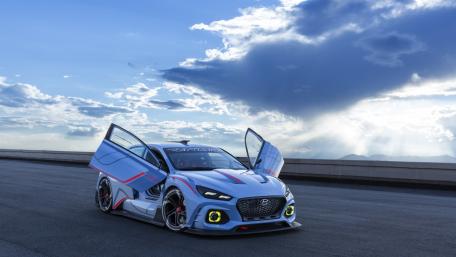 Dynamic Blue Hyundai Race Car in Stunning Sky Backdrop wallpaper
