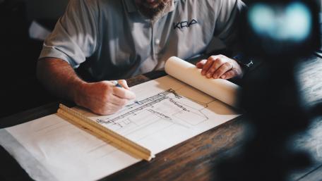 Architect's Hands Crafting Plans in 4K Clarity wallpaper