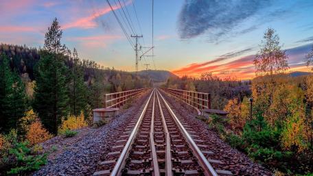 Tranquil Sunset Over Train Tracks in Nature wallpaper