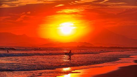 Surfers in the sunset wallpaper