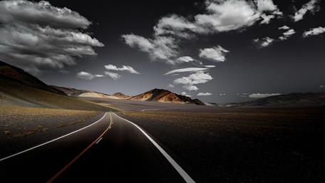 Endless road with fluffy clouds wallpaper