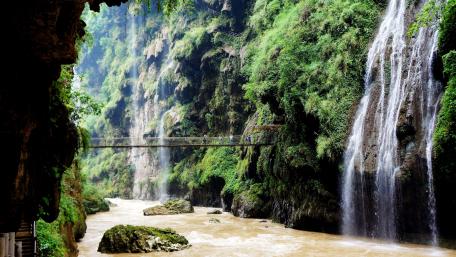 Bridge Over Majestic Canyon Waterfall wallpaper