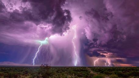 Purple Storm and Lightning Strikes Over Fields wallpaper