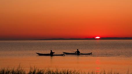 Rowing boats in the sunset wallpaper