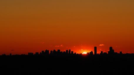 City Silhouette at Sunset with Red Sky wallpaper
