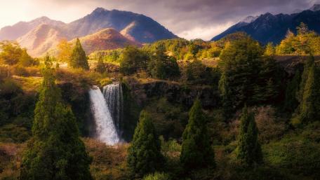 Majestic Waterfall Surrounded by Autumn Foliage wallpaper