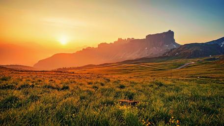 Majestic Sunrise Over Highland Meadows wallpaper