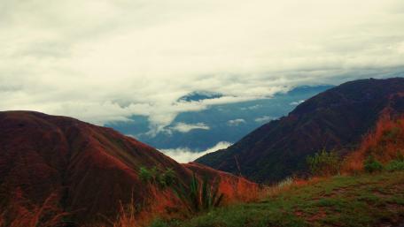 Majestic Mountains Under Rolling Clouds wallpaper