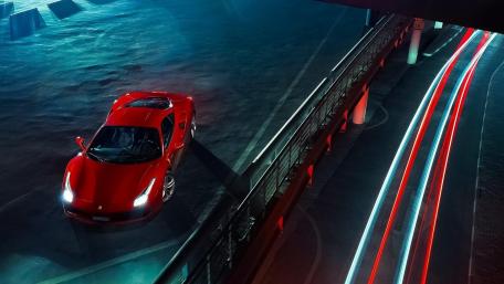 Dynamic Red Ferrari Under Night Lights wallpaper