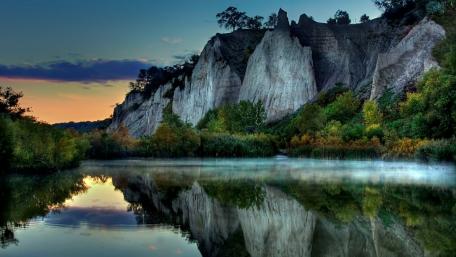 White cliff reflected in the calm lake wallpaper