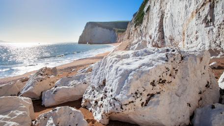Serene Coastal Cliffs with Glittering Sea Views wallpaper