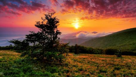 Majestic Sunset Over Highland Hills wallpaper