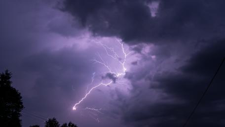 Majestic Lightning Strikes Across Darkened Evening Sky wallpaper