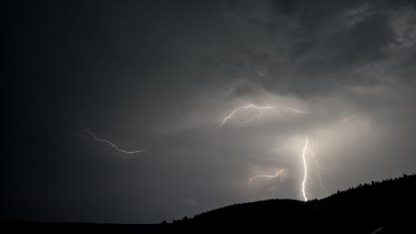 Epic Evening Thunderstorm with Striking Lightning Show wallpaper