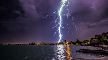 Majestic Lightning Over Tranquil Waters wallpaper