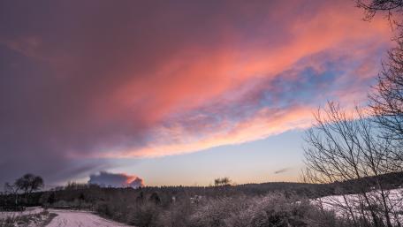 Serene Winter Sunset Over Snowy Landscape wallpaper