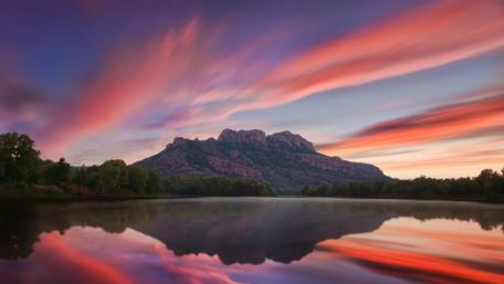 Serene Sunset Reflection over the Tranquil Loch wallpaper