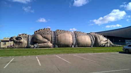 Giant Iguana Sculpture in Urban Landscape wallpaper
