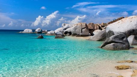 Azure Waters and Sun-Kissed Rocks wallpaper