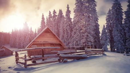 Wooden house under snow wallpaper