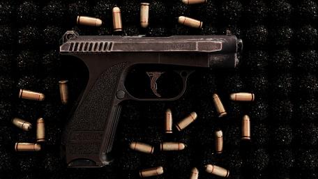 Sleek Pistol Surrounded by Bullets wallpaper