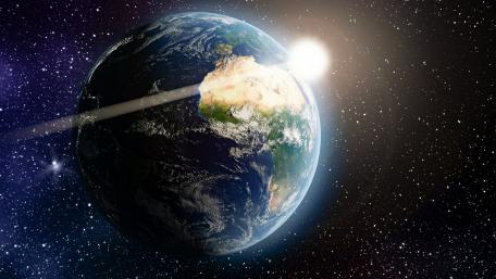 Earth in Space with Rising Sun wallpaper