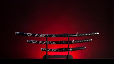 Samurai Swords Silhouetted Against Crimson Glow wallpaper