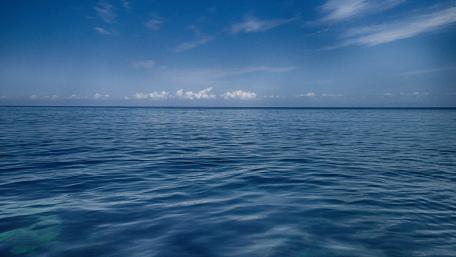 Tranquil Blue Waters Under a Clear Sky wallpaper