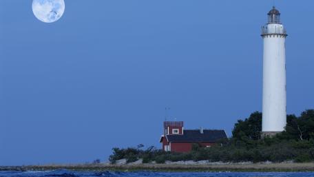 Serene Lighthouse Under a Full Moon wallpaper