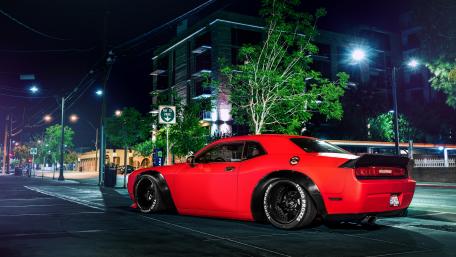Sleek Red Sports Car in Urban Nightscape wallpaper