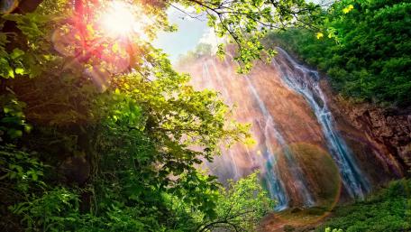 Majestic Waterfall Embraced by Nature's Beauty wallpaper