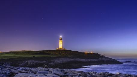 Serenity at the Lighthouse Under a Starry Sky wallpaper