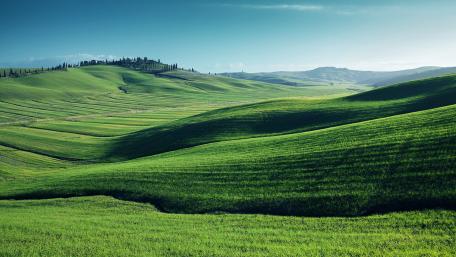 Lush Green Highlands Under a Clear Blue Sky wallpaper