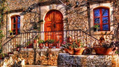 Charming Hacienda Facade with Vibrant Flora wallpaper