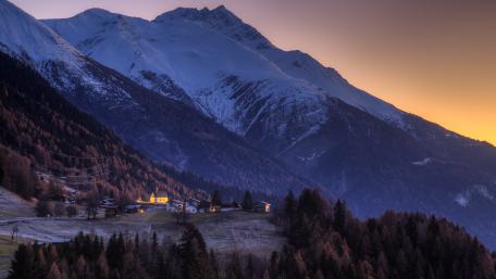 Serene Winter Dawn Over Alpine Village wallpaper