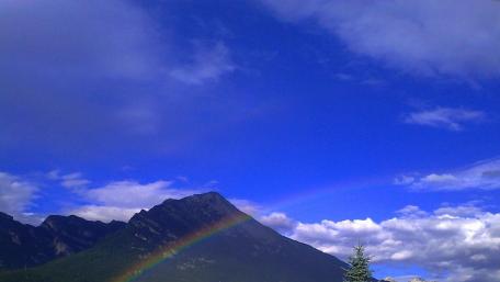 Vibrant Rainbow Over Majestic Mountain Scene wallpaper