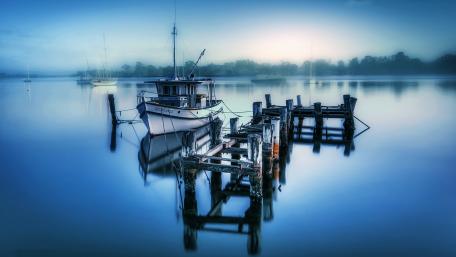 Serene Morning Reflection on Calm Waters wallpaper