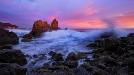 Serene Dawn Over Rocky Shoreline wallpaper